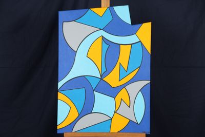 peinture représentant une œuvre abstraite bleue et jaune posée sur un chevalet en bois