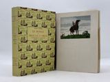 the book is open to show a picture of a man on a horse