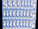 several packs of pokemon trading cards are stacked on top of each other