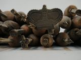 a pile of nuts with a crown on top of them