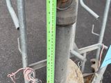 a measuring tape on a pole next to a fire hydrant