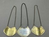 three silver and gold plated necklaces with the names of three people