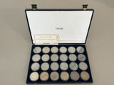 a box of silver coins sitting on top of a table