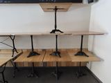 three wooden benches sitting in front of a chalk board
