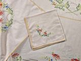 a white table cloth with a floral design on it