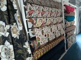 a lot of fabric on a rack in a room