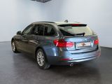 the back of a silver bmw x3 parked in a showroom