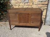 a wooden chest sitting on a gravel ground