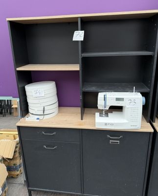 a sewing machine sitting on top of a cabinet in a room