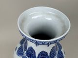 a blue and white vase sitting on a table