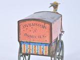a small toy cart with a bird sitting on top of it