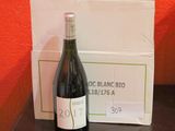 a bottle of wine sitting on a table next to a box of wine