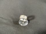 a silver ring that is sitting on a black surface