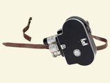 a black and white photo of a camera with a brown strap