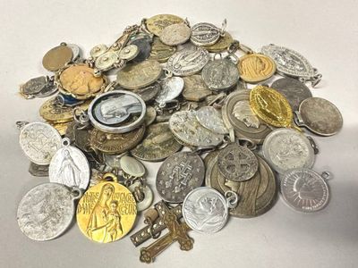 a pile of silver and gold coins on a white table
