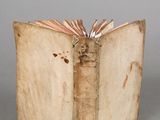 an old book that is open on a table