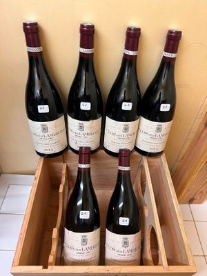 six bottles of wine in a wooden box on a tiled floor