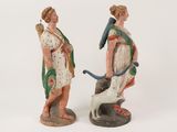 two figurines of a woman and a dog on a white background