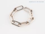 silver plated link bracelet with square links on a white background