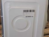 a white washer sitting on a pallet in a room