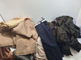 a pile of clothes sitting on the floor next to a wall