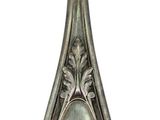 a silver spoon with a picture of a woman on it