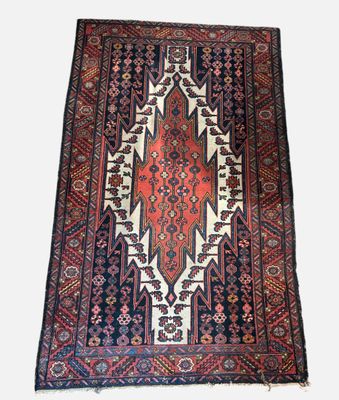 a rug with a red and blue design on a white background
