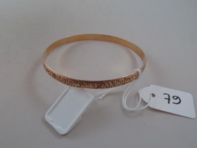 a bracelet and a cell phone on a white table