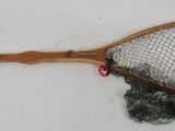 a wooden racket with a net attached to it