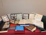 a lot of books on a table with a red table cloth