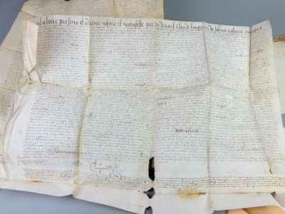 an old paper with writing on it sitting on top of a table