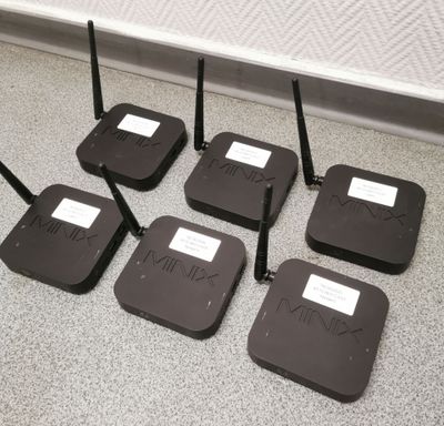 six wireless routers sitting on the floor next to each other