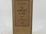 an old book sitting on top of a table next to a white table