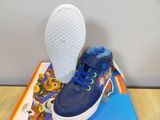 blue toddler ' s shoes with paw patrol on top of a book