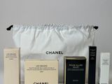 chanel makeup set in a white bag with a black handle