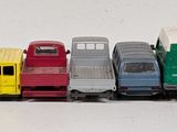 a lot of toy trucks that are lined up on a table