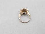 a close up of a gold ring with a flower on it