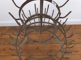 an image of a metal basket on a wooden floor with a white wall in the background