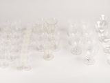a lot of empty wine glasses on a white table