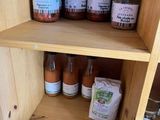 many jars of food on a shelf in the kitchen