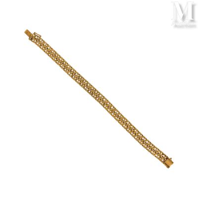 a close up of a gold bracelet on a white background