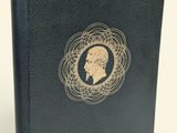 a black book with a gold medallion on the cover