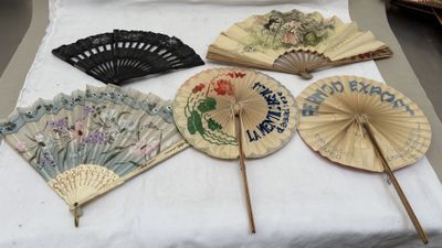 many different types of hand fans on display on a table