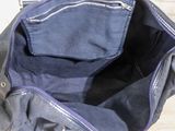 a blue bag that is sitting on a wooden floor