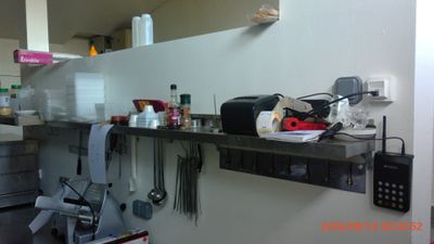 a picture of a kitchen with a lot of utensils on the counter