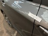 a sticker on the door of a car that is parked in a parking lot