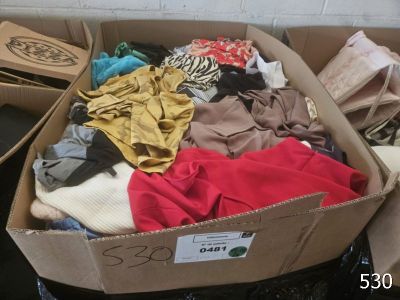 a cardboard box full of clothes sitting on top of a table