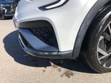 the front end of a white suv parked in a parking lot