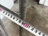 a measuring tape on a metal pole in a garage