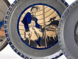 three plates with different designs on them on a white surface